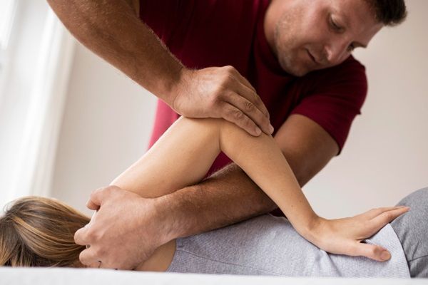 Masajes - Masajista aplicando técnicas de masajes relajantes a una mujer para aliviar dolores musculares