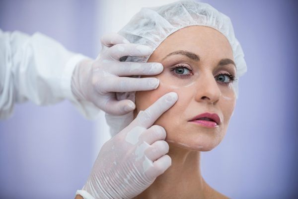 Daxxifi - Médico estético evaluando el rostro de una mujer para aplicar toxina botulínica y rejuvenecer la piel en la mejor clínica estética Madrid