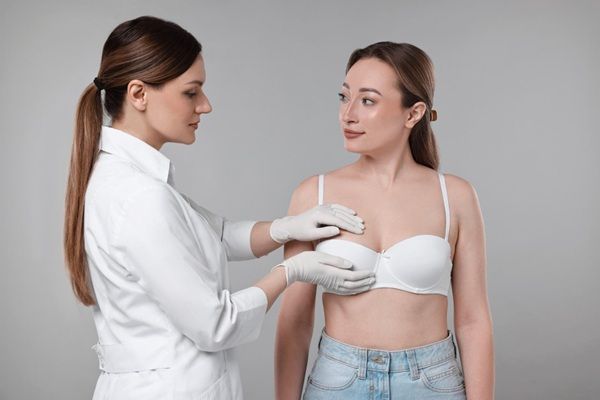 Aumento de senos sin cirugía - Especialista de la mejor clínica ácido hialurónico Madrid evaluando el busto de una mujer para un aumento de senos con ácido hialurónico Madrid